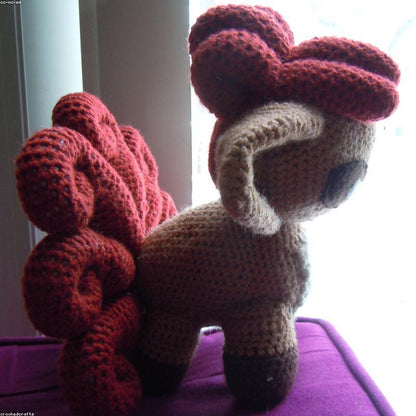 Daisy Bag held in hands demonstrating tactile plush scale and soft texture