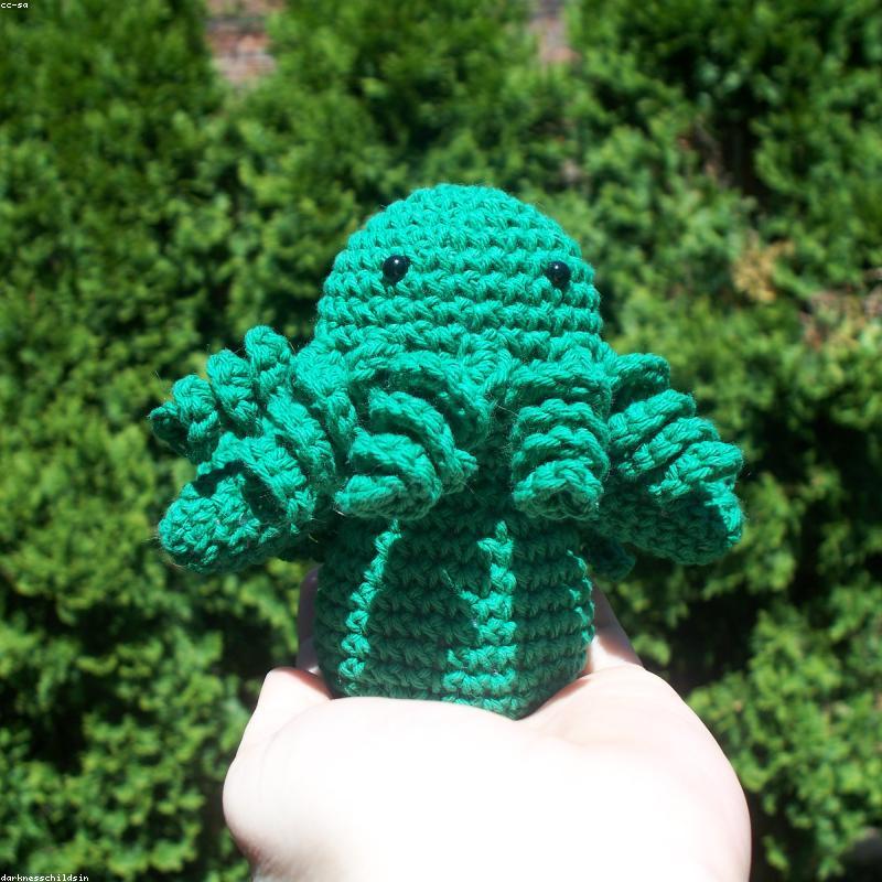 Strawberry held in hands demonstrating tactile plush scale and soft texture