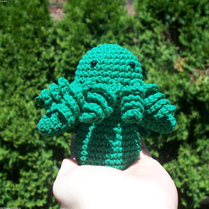 Strawberry held in hands demonstrating tactile plush scale and soft texture